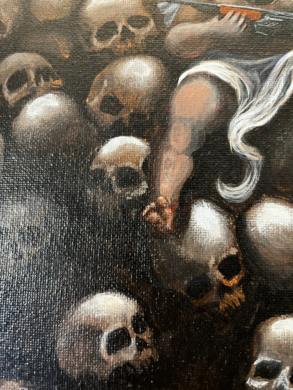 Love holds rifle on pile of skulls